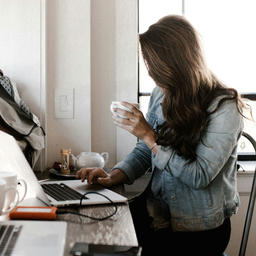 An online student doing classwork from a coffee shop