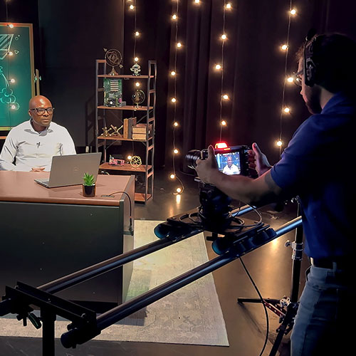 A photo of a Sam Poly lecture being recorded by an Online Media Innovation team member