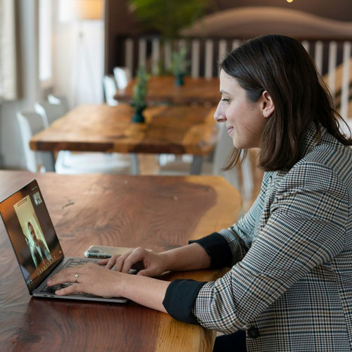 An instructor using their laptop to teach an online class